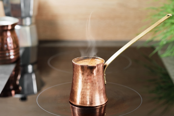 coffee time freshly ground coffee is brewed in a copper traditional turk foam on a coffee steam rises over cezve closeup selective focus idea of making coffee for breakfast - Кофе с сахаром и солью в турке