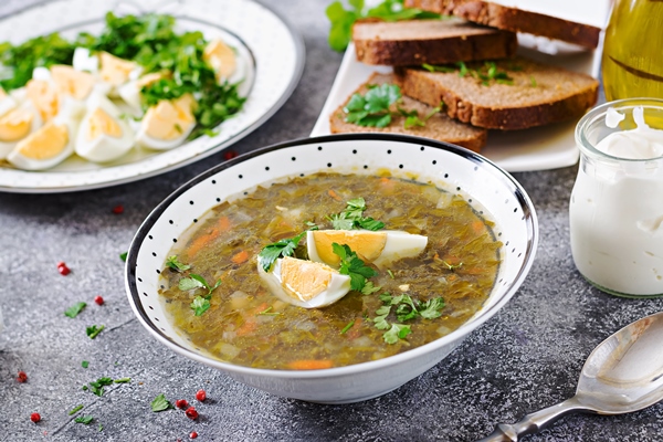 green sorrel soup with eggs summer menu healthy food - Щавелевый суп