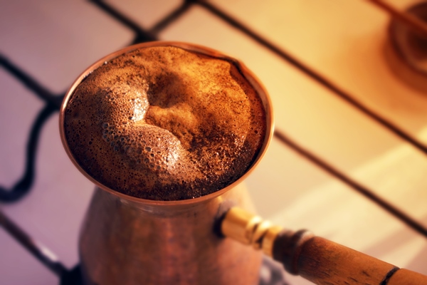 hot turkish coffee made in ooper cezve traditional coffee pot on a gas stove - Кофе с лимоном
