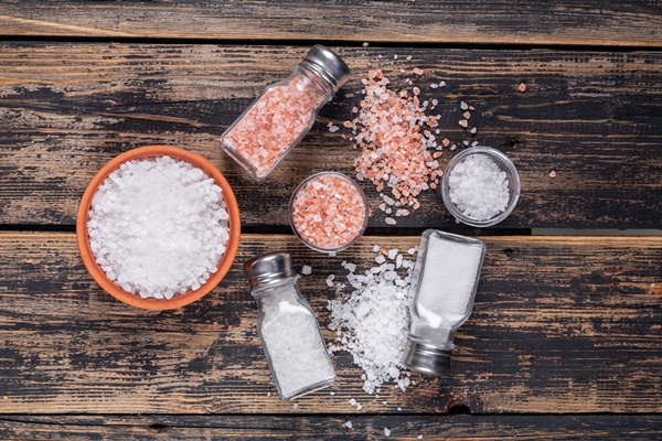 some sea salt and himalayan salt in bowls and coming out of salt shakers - Суп-пюре картофельный с молоком