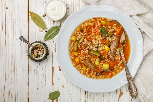 thick hearty pickle soup with beef vegetables pickles carrots onions potatoes tomatoes and pearl barley - Рассольник