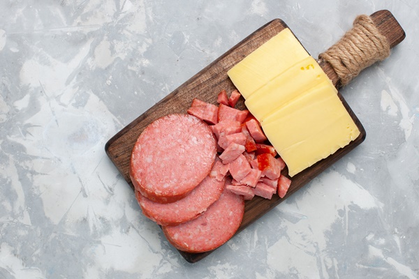 top view sliced sausages with cheese on white - Омлет "с разностями"