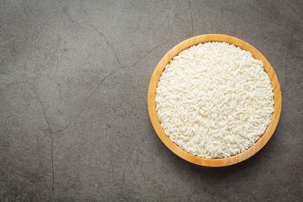 white rice on small wooden plate place on dark floor - Харчо