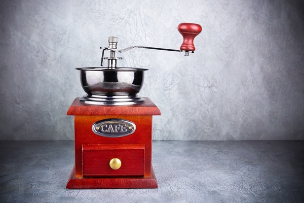 wooden brown coffee grinder with drawer on grey background - Кофе с сахаром и солью в турке