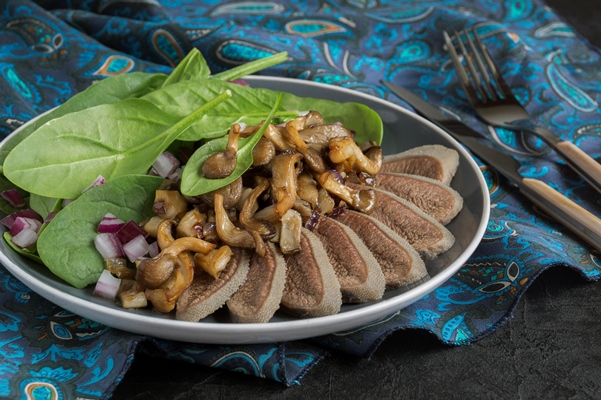 boiled beef tongue with fried mushrooms a cold appetizer a delicacy - Язык отварной под соусом