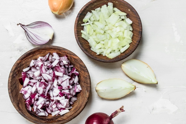 chopped red and yellow onions in a bowl - Кулеш со свининой