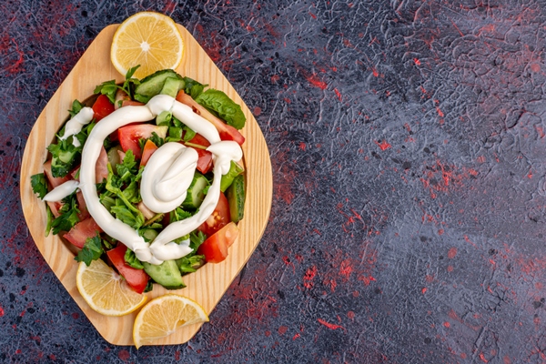 green salad in a wooden platter with mayonnaise sauce - Соус майонез острый
