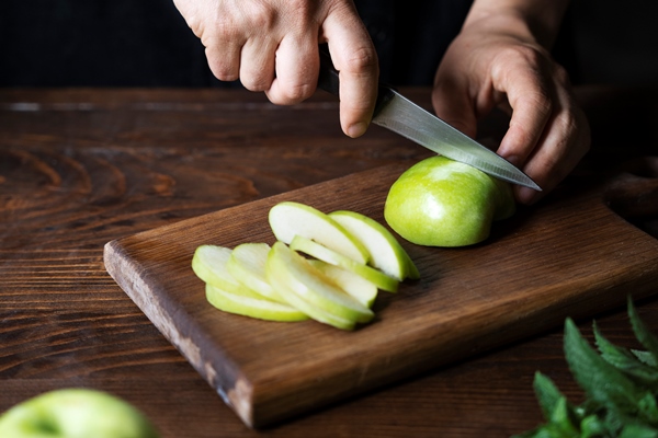 high angle hands cutting apple - Салат из сельди