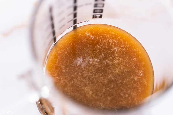 homemade caramel glaze for bundt cake cooling in a glass measuring cup - Соус "Южный"