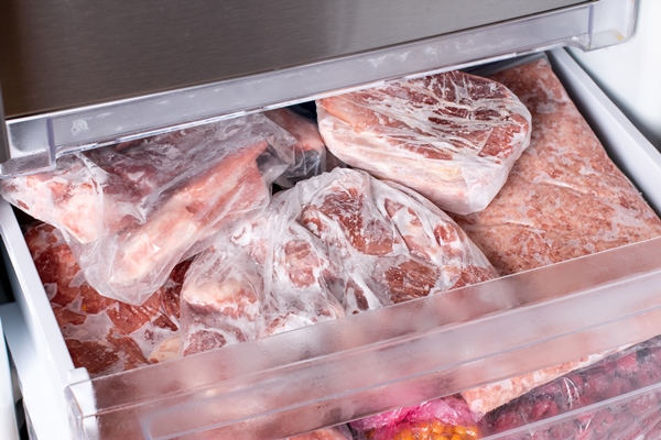 meat in refrigerator freezer background closeup pork meat and chicken leg in freezing compartment frozen food - Правила выбора и приготовления мяса