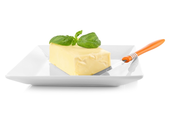 plate with butter and shovel on white background closeup - Суп молочный с картофельными клёцками