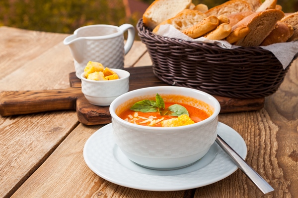 some delicious soup meal with bread in a bowl with forest on background high angle view - Сырный суп с копчёностями и молоком