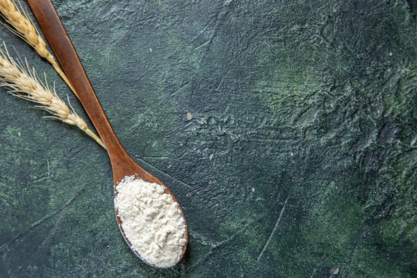 top view flour on wooden spoon on dark desk - Сырный суп с копчёностями и молоком