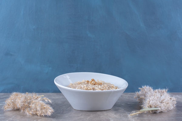 a white bowl with tasty healthy oatmeal porridge for breakfast - Монастырская кухня: овсяная каша, закуска из баклажанов