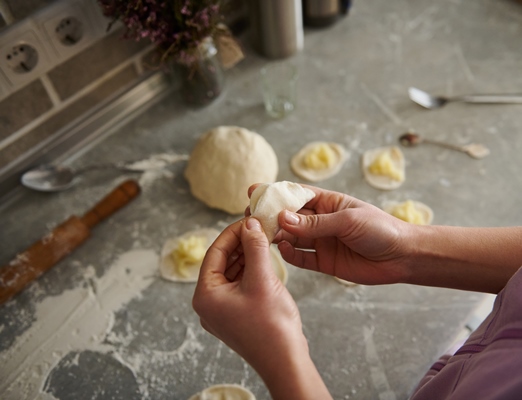 a woman sculpts dumplings in the kitchen portrait of hands - Монастырская кухня: кабачки с тофу, картофельные вареники с грибами, кукуруза с мёдом