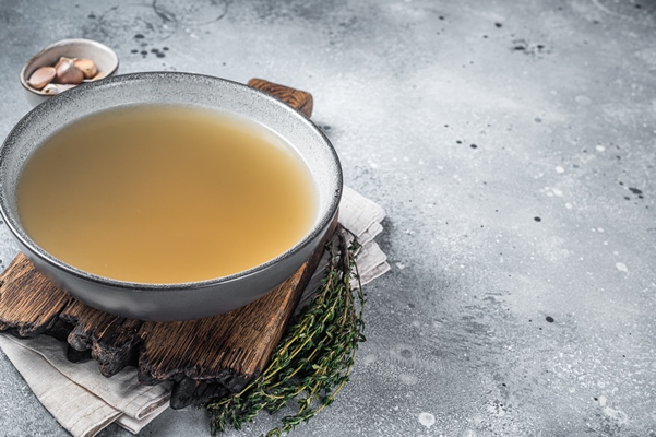 bone meat chicken broth in a plate gray background top view copy space - Соус красный