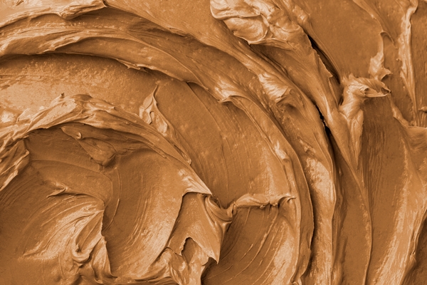 brown frosting texture background close up - Урбеч из кешью с кокосом