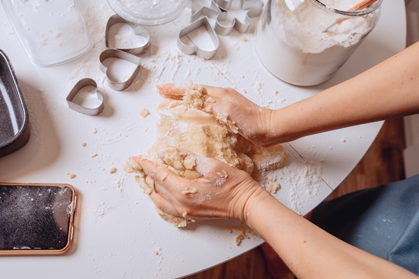 close process of rolling out the dough with your hands the housewife makes and kneads the dough by hand for a nice texture home cooking of biscuits mixing ingredients is a mass for baking cookies - Монастырская кухня: суп "Святогорский", печенье курабье