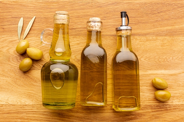close up olive bottles yellow olives and leaves - Монастырская кухня: манный мусс с клюквой и расстегаи