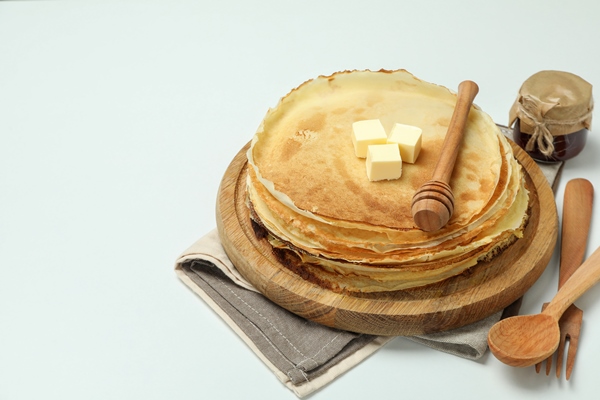 concept of tasty food with crepes on white background - Блинцы на ряженке