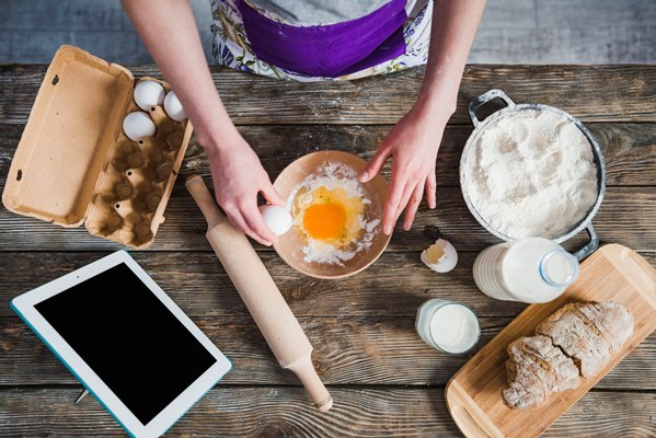 crop woman adding eggs to flour - Пирожки из пресного теста
