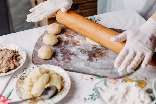 dough meat meal pastry in process of making dough cook on brown wood rustic desk - Монастырская кухня: манный мусс с клюквой и расстегаи