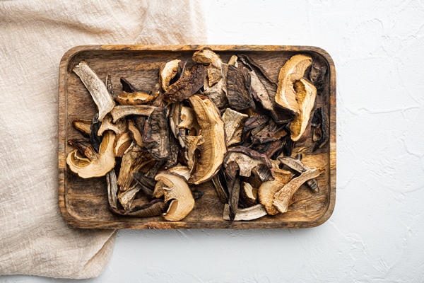 dried wild mushrooms set on white background top view flat lay - Монастырская кухня: грибной бульон с расстегаями, кулеш