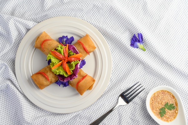 egg roll or fried spring rolls on the white plate thai food top view - Блинчики с крабовыми палочками