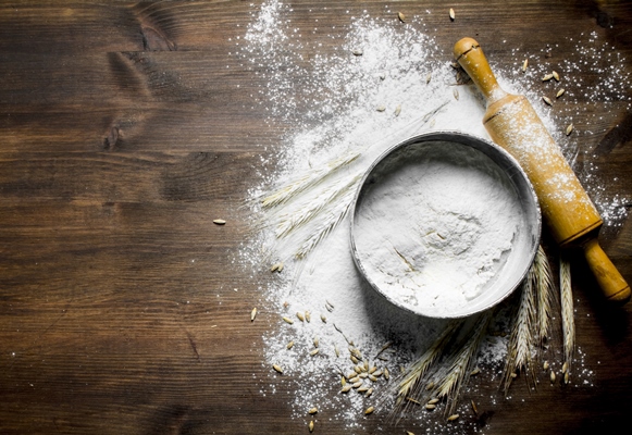 flour with a sieve rolling pin and spikelets on wooden table - Монастырская кухня: оладьи из картофеля, жареные яблоки и сорбет
