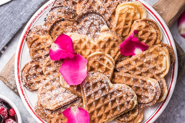 freshly baked homemade heart shaped belgium waffles on gray background european baked pastry sweets - Монастырская кухня: картофельные котлеты, маково-ореховые вафли