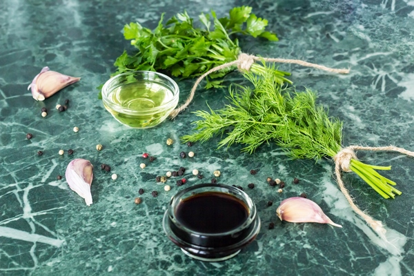 herbs and spices on marble stone table parsley dill garlic olive oil soy sauce and pepper - Шашлык из шампиньонов
