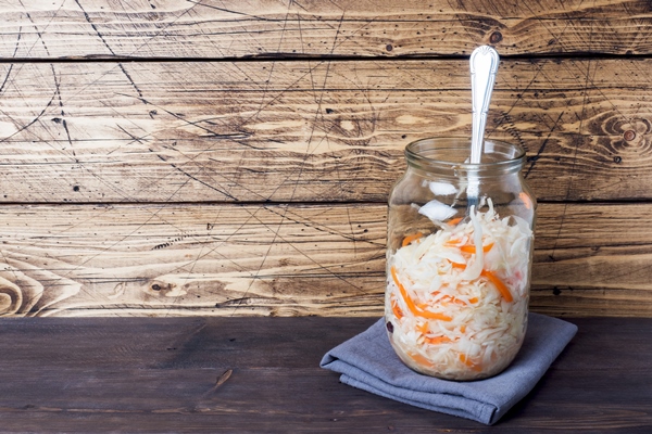 homemade sauerkraut with carrots and cranberries in glass jar on wooden copy space - Монастырская кухня: овсянка с луком и изюмом, квашеная капуста