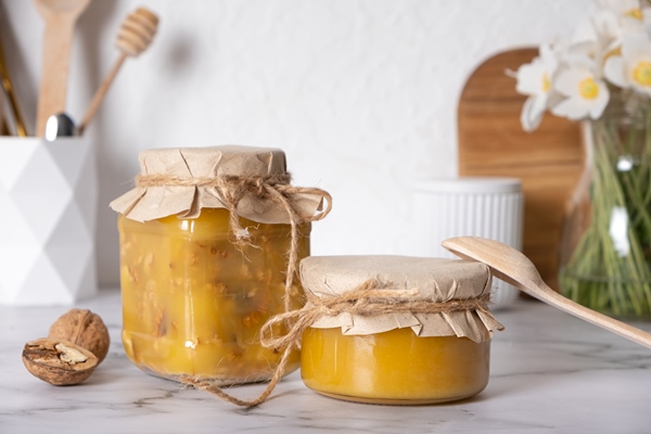 jars with honey and walnuts walnuts in honey in the kitchen interior - Манка без варки с фруктами
