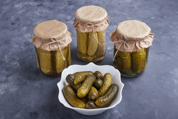 pickled cucumbers in bowl and glass jars on blue surface - Монастырская кухня: рассольник, постные блинчики с яблоками