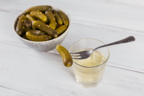 pickled juice pickle and marinated cucumber in a bowl clean eating vegetarian food concept - Монастырская кухня: пшённая каша в тыкве, постное печенье на рассоле