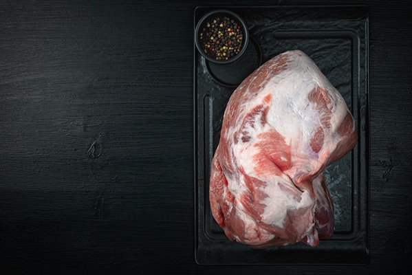 raw pork meat on wooden black background - Правила приготовления блюд из рубленого мяса