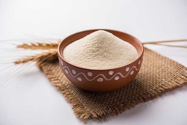 raw unprepared semolina flour also known as rava powder in hindi in bowl or spoon close up isolated on white or moody background selective focus 2 - Монастырская кухня: рис с баклажанами, ревани