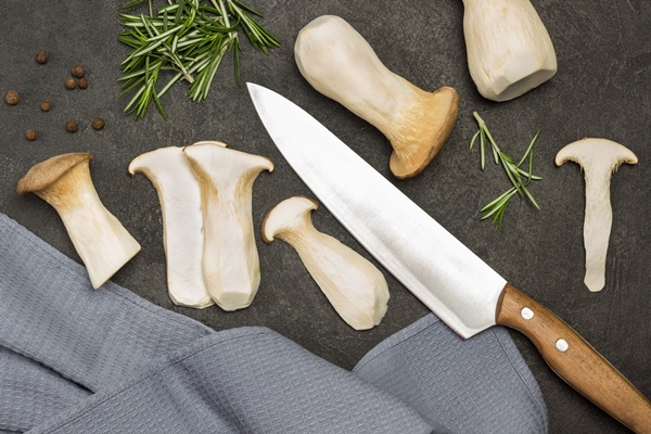 sliced mushrooms rosemary sprigs and kitchen knife - Вешенки жареные в маринаде
