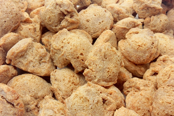soy meat in chunks on white background top view of raw soybeans chunks - Сейтан (клейковина)