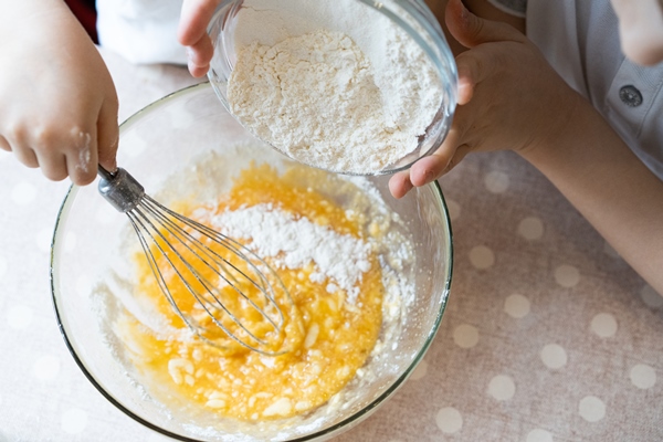 the process of making dough for pancakes with ingredients on a light table eggs and flour are whipped with a mixer 4 - Блинчики с яблоками
