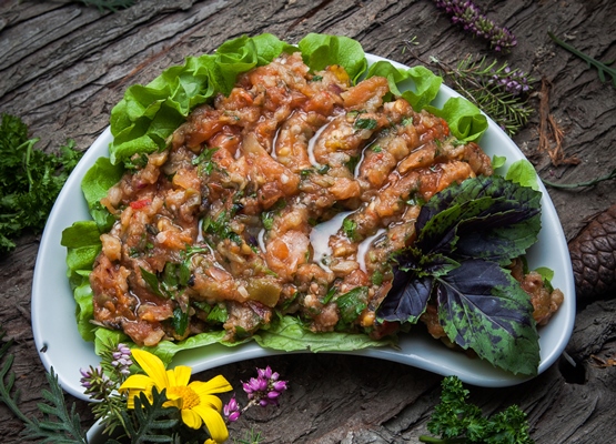 top view eggplant caviar with lettuce basil in a white plate - Монастырская кухня: овсяная каша, закуска из баклажанов