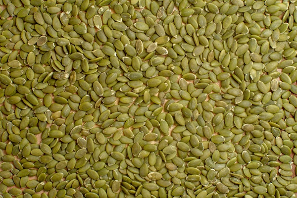 top view of green pumpkin seeds seed nut many green - Урбеч десертный из тыквенных семечек