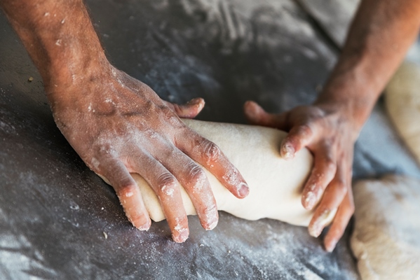 baker preparing bread close up of hands kneading dough bakery concept - Жаворонки
