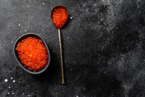 salmon red caviar in an exquisite spoon black surface top view copy space - Особенности питания детей