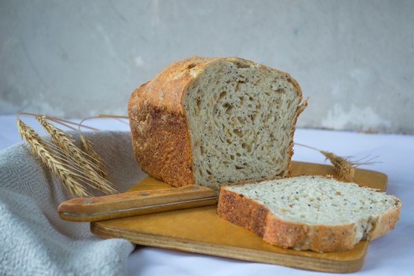 whole grain bread with flax seeds and rye sourdough still life in a rustic style - Камбала с помидорами