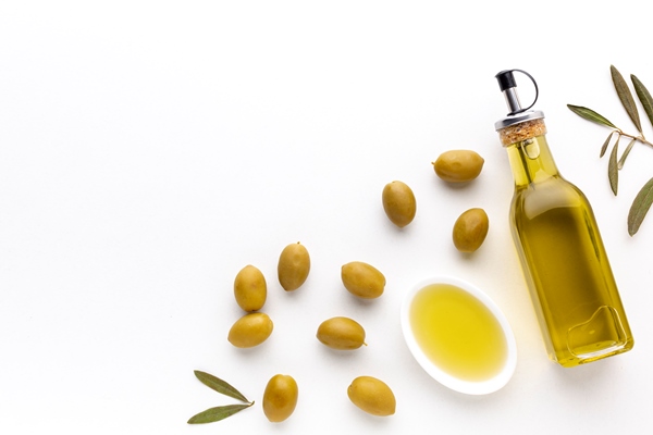 high angle olive oil bottle and saucer with yellow olives and copy space - Паштет из черемши с томатами