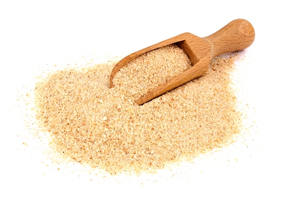 pile of breadcrumbs and spoon isolated on white - Запеканка с лебедой