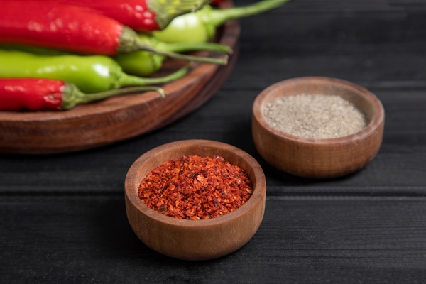 red and green hot chili peppers placed in a wooden bowl with spices high quality photo - Жареная черемша