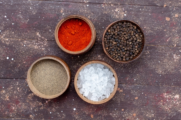 top view of different seasonings salt pepper inside brown bowls on brown salt pepper ingredient dried - Котлеты из черемши