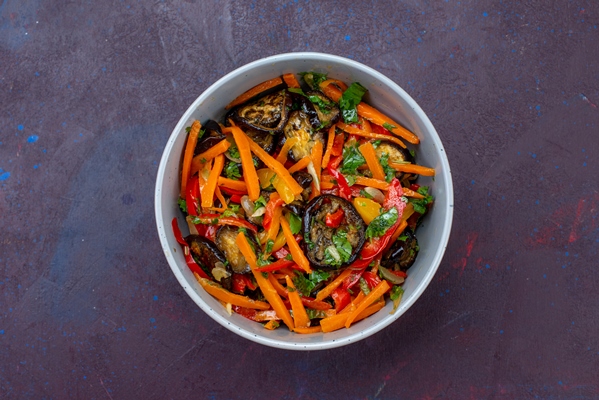 top view sliced vegetable salad inside plate on the dark blue surface - Жареный корень лопуха